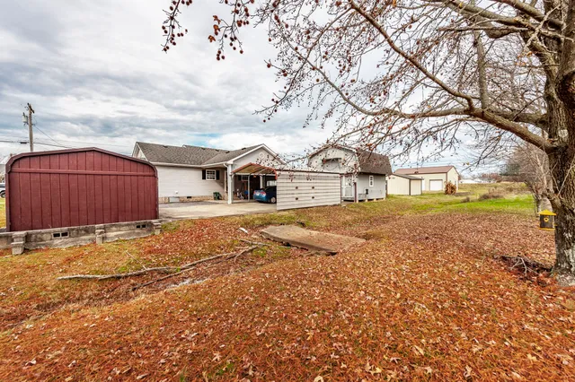 a view of a house with a yard covered in snow