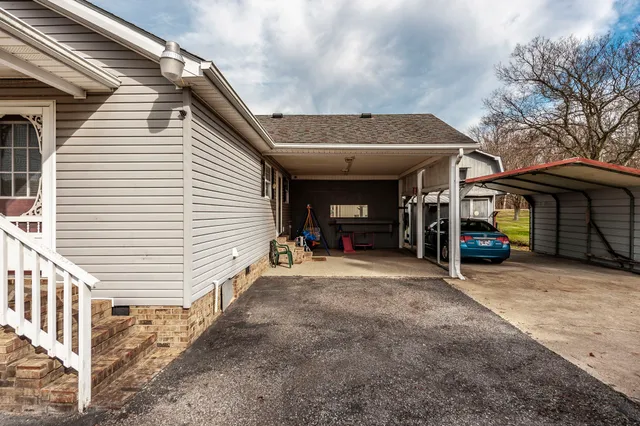 a view of a house with a yard and garage