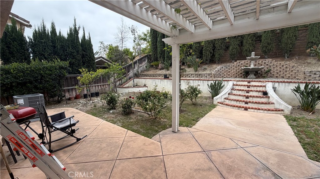 7134 Cumberland Place Rancho Cucamonga, CA 91739 - Photo 20 of 22 a view of a patio with table and chairs with wooden floor and fence