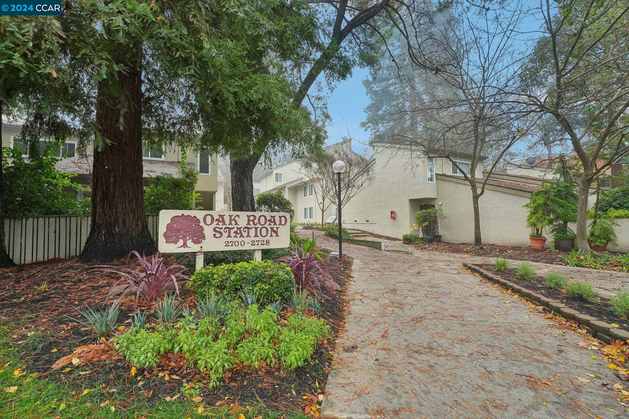 2700 Oak Road, Unit 26 Walnut Creek, CA 94597 - Photo 1 of 1 a backyard of a house with table and chairs