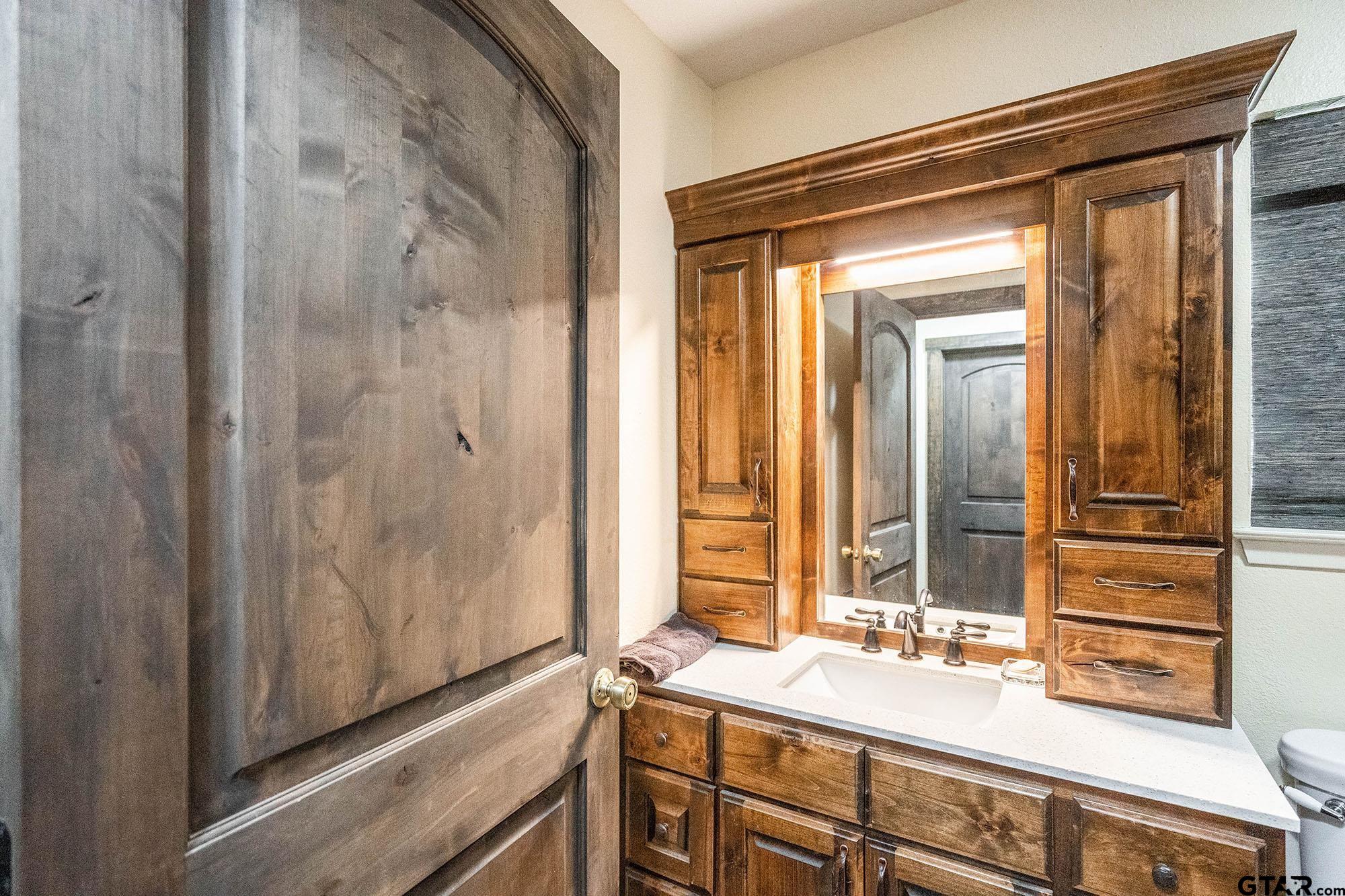 6523 North Sparta Avenue Odessa, TX 79764 - Photo 11 of 38 a bathroom with a granite countertop sink and a mirror