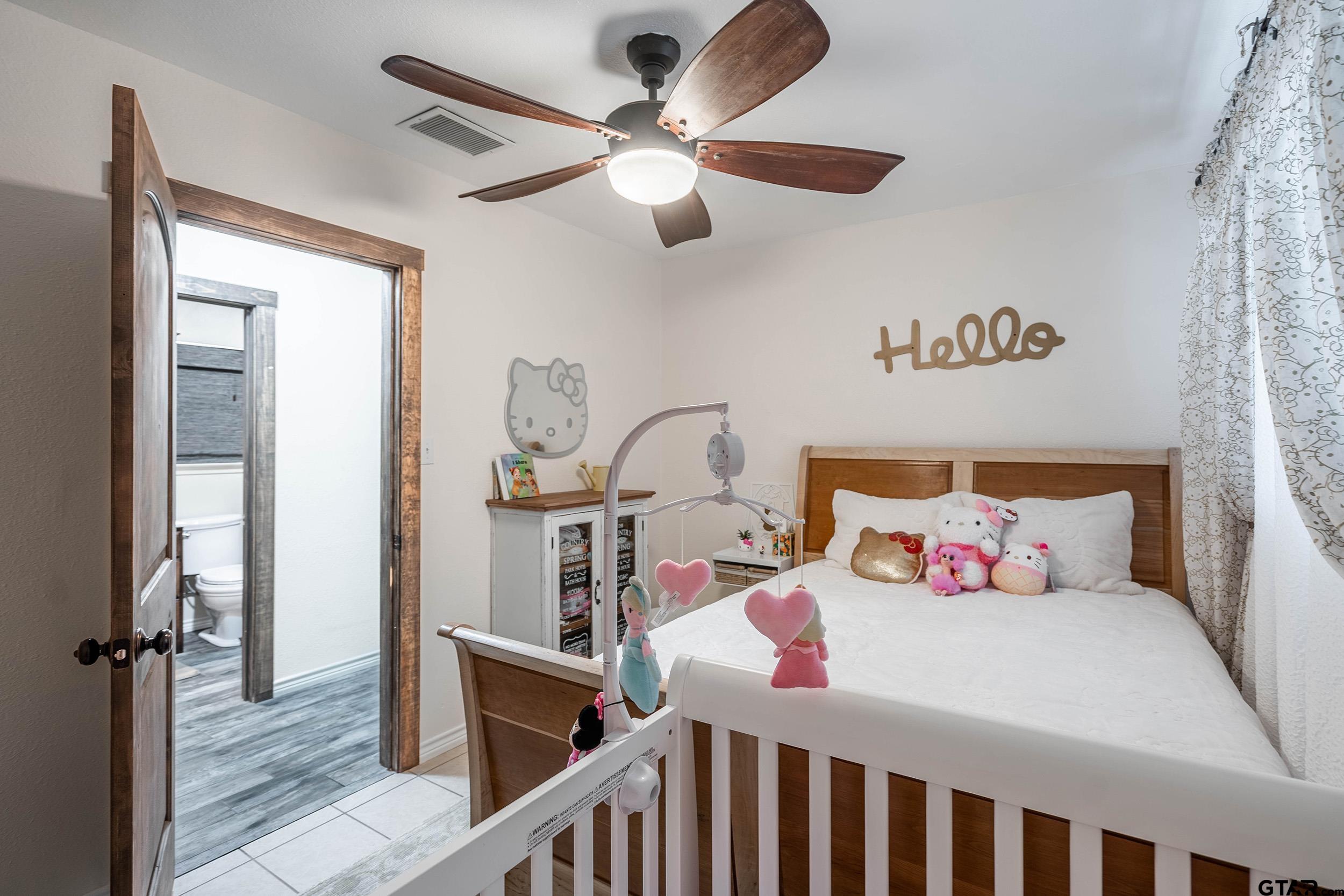 6523 North Sparta Avenue Odessa, TX 79764 - Photo 15 of 38 a bedroom with a bed and a chandelier