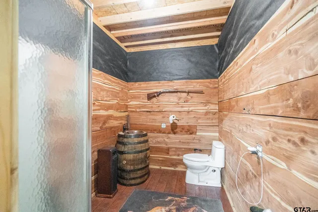 a bathroom with a toilet and a shower curtain
