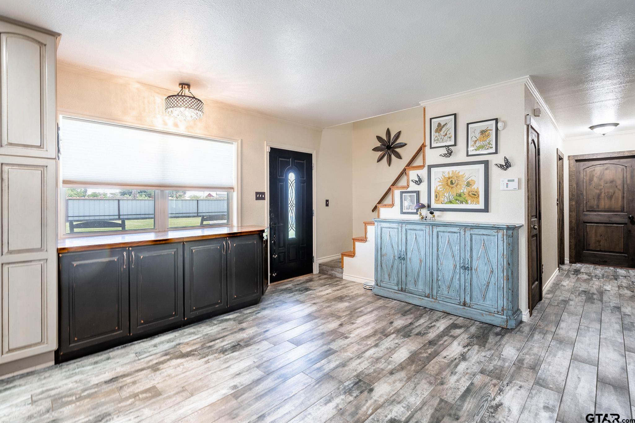 6523 North Sparta Avenue Odessa, TX 79764 - Photo 2 of 38 a view of a kitchen with an entryway and wooden floor