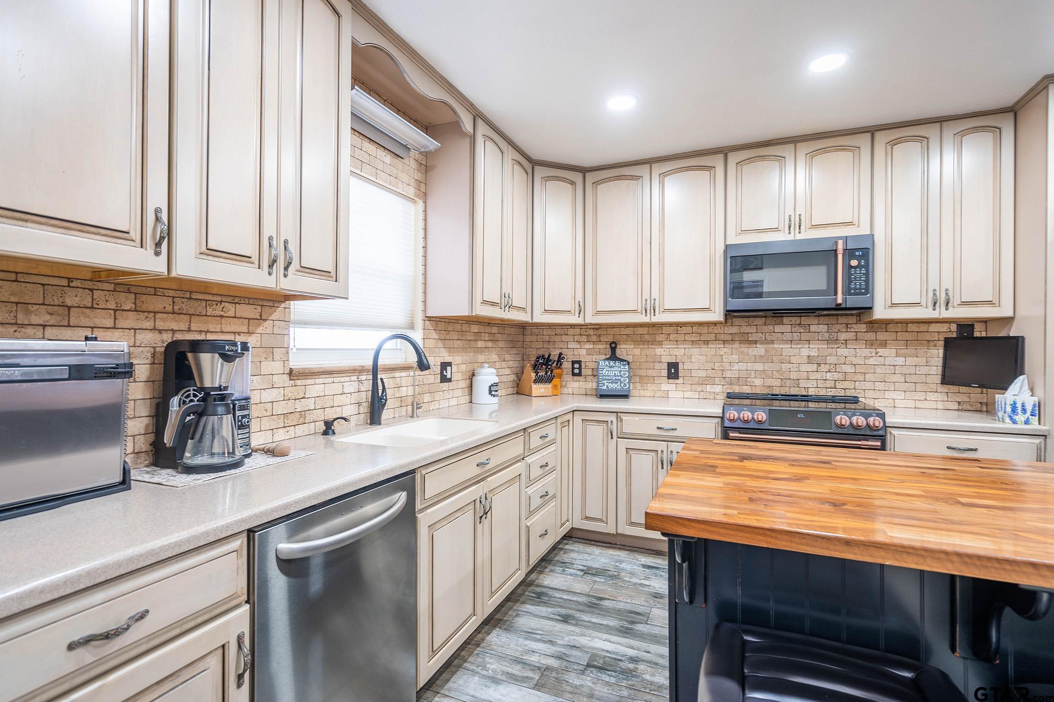 6523 North Sparta Avenue Odessa, TX 79764 - Photo 5 of 38 a kitchen with stainless steel appliances granite countertop a sink a stove and cabinets
