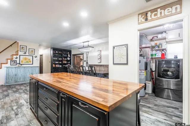 a kitchen with stainless steel appliances granite countertop a kitchen island a stove and a refrigerator