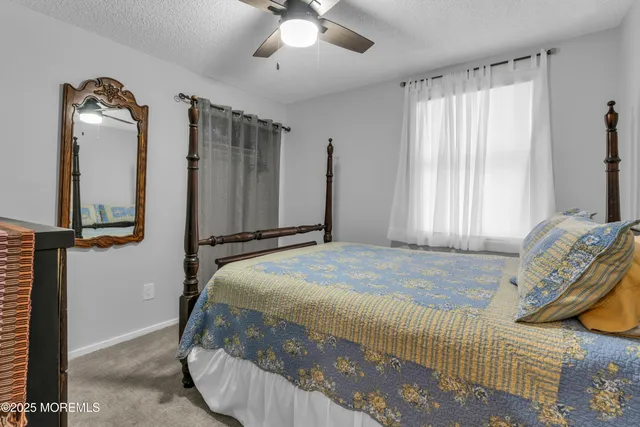 a bedroom with a bed and a mirror