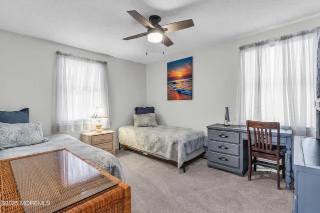 a living room with furniture and a ceiling fan