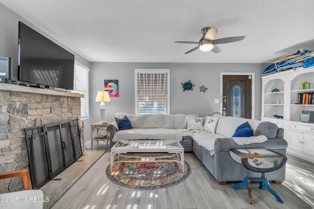 a living room with furniture and a fireplace