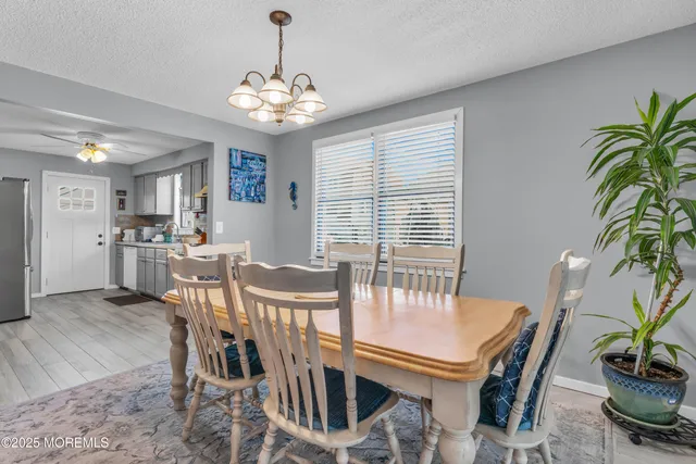 a view of a dining room with furniture and chandelier