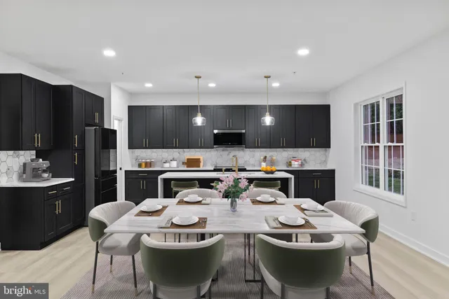 a kitchen with stainless steel appliances kitchen island granite countertop a sink a stove a dining table and chairs