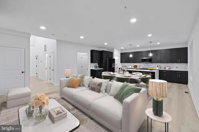 a living room with furniture and kitchen view