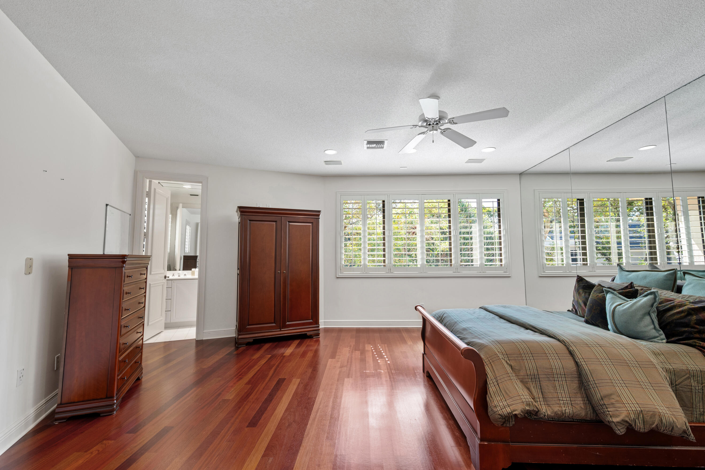 18800 Long Lake Drive Boca Raton, FL 33496 - Photo 36 of 60 a spacious bedroom with a bed and wooden floor