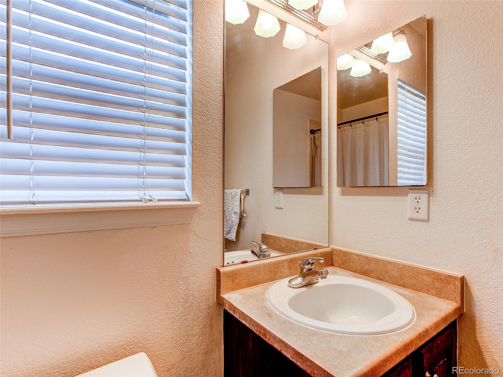 10850 Towerbridge Road Highlands Ranch, CO 80130 - Photo 16 of 24 a bathroom with a sink and a mirror