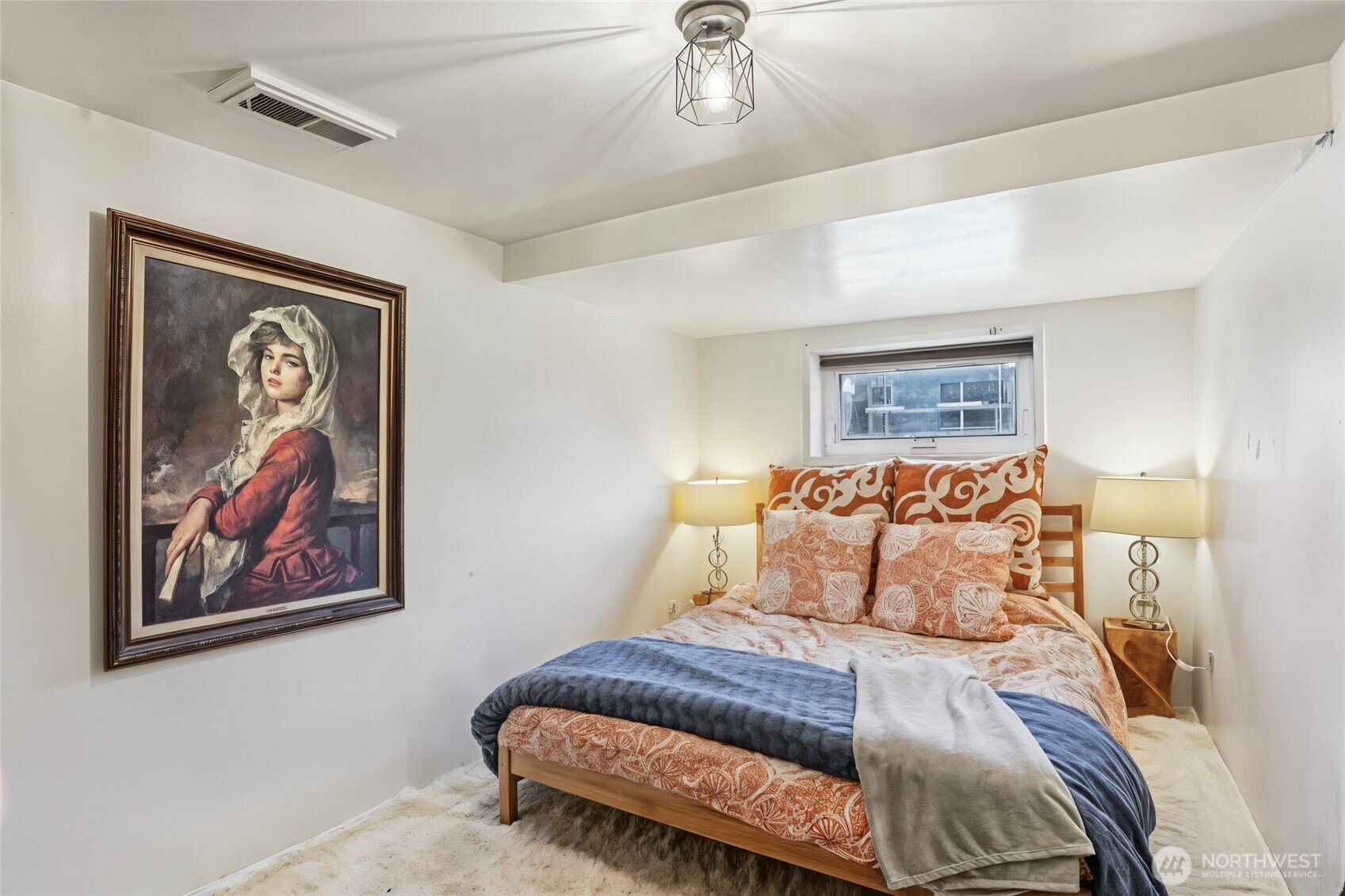 1113 33rd Avenue South Seattle, WA 98144 - Photo 18 of 28 a bedroom with a bed and lamp