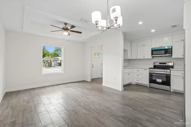 a view of kitchen with sink microwave and cabinets
