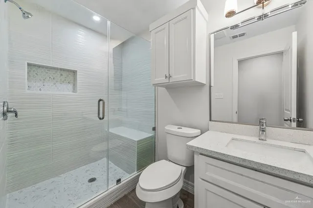 a bathroom with a toilet a sink and shower