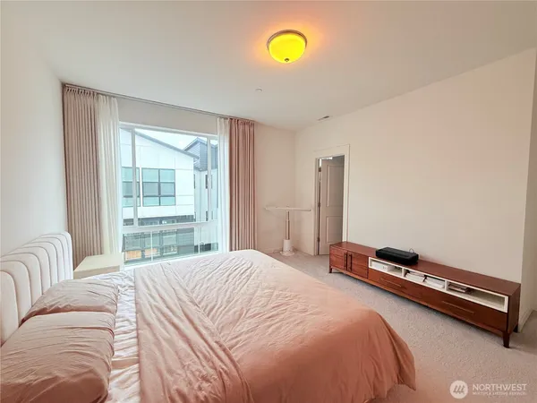 a bedroom with a bed and window