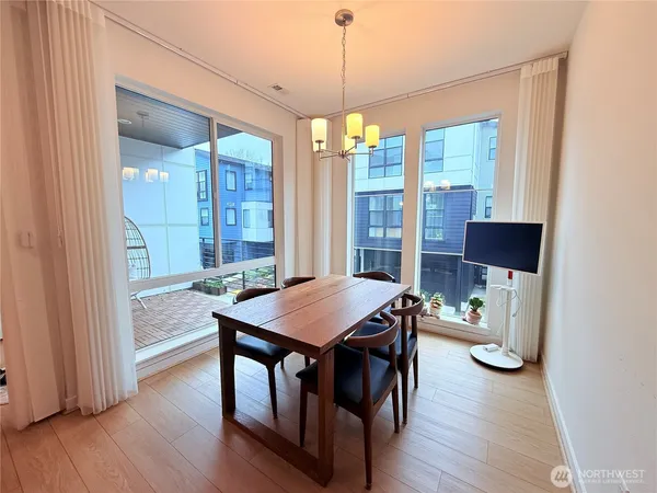a view of a dining room with furniture window and wooden floor