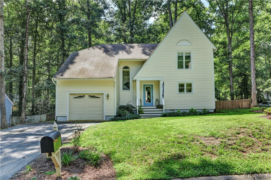 5612 Woods Walk Road Midlothian, VA 23112 - Photo 1 of 26 a front view of a house with a yard