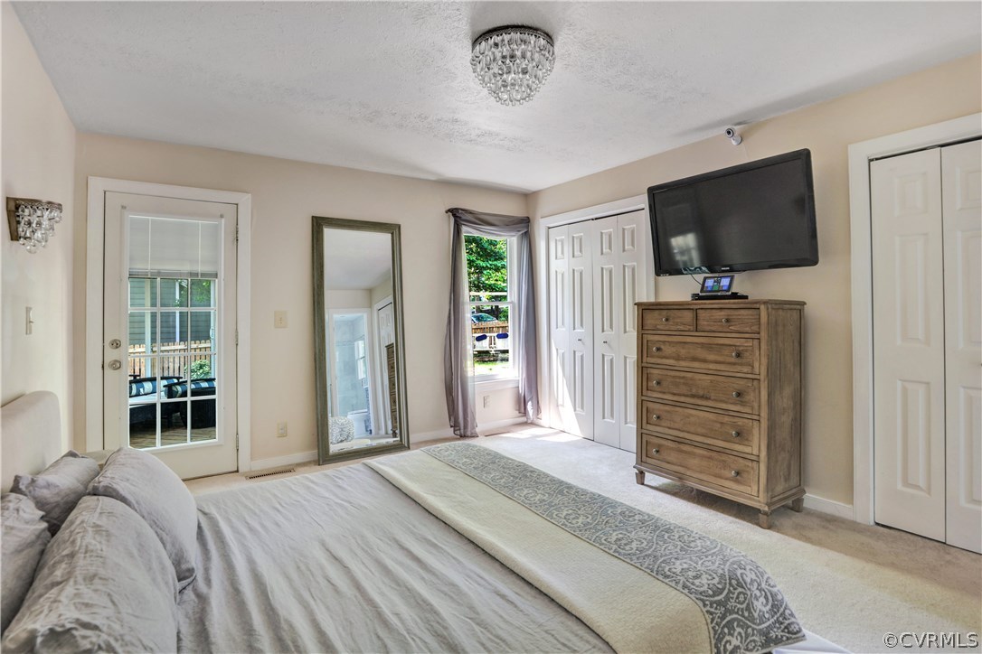 5612 Woods Walk Road Midlothian, VA 23112 - Photo 13 of 26 a bedroom with a bed and a flat screen tv