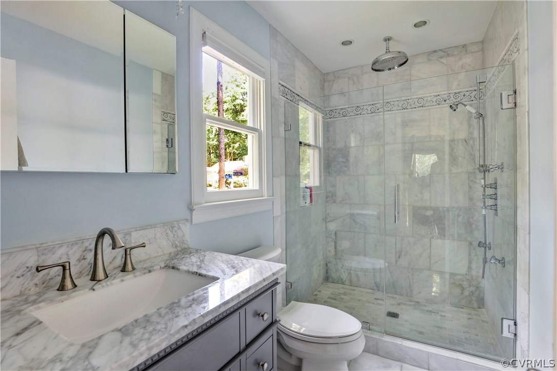5612 Woods Walk Road Midlothian, VA 23112 - Photo 15 of 26 a bathroom with a granite countertop sink a toilet and shower
