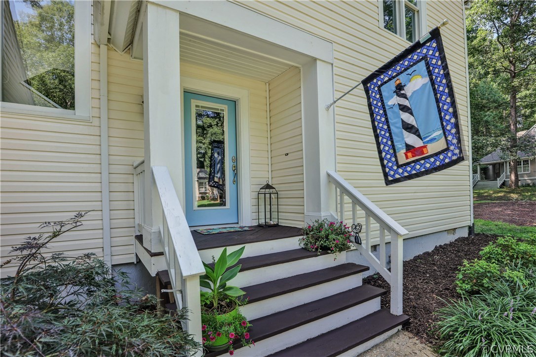 5612 Woods Walk Road Midlothian, VA 23112 - Photo 3 of 26 a house with potted plants in front of it