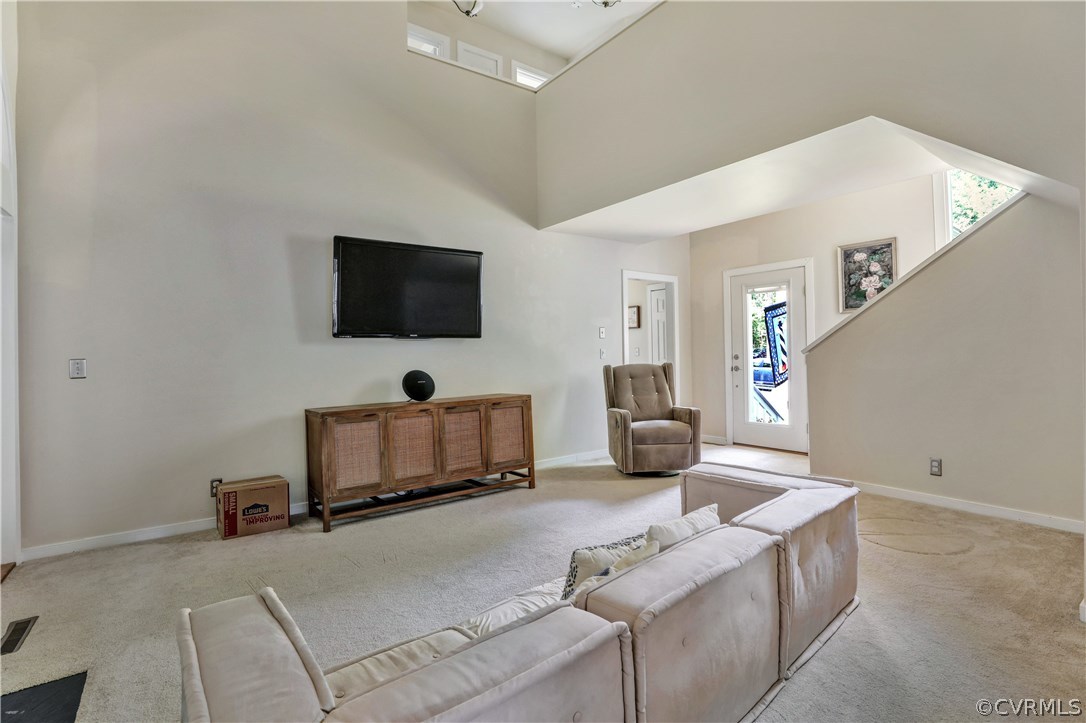 5612 Woods Walk Road Midlothian, VA 23112 - Photo 4 of 26 a living room with furniture and a flat screen tv