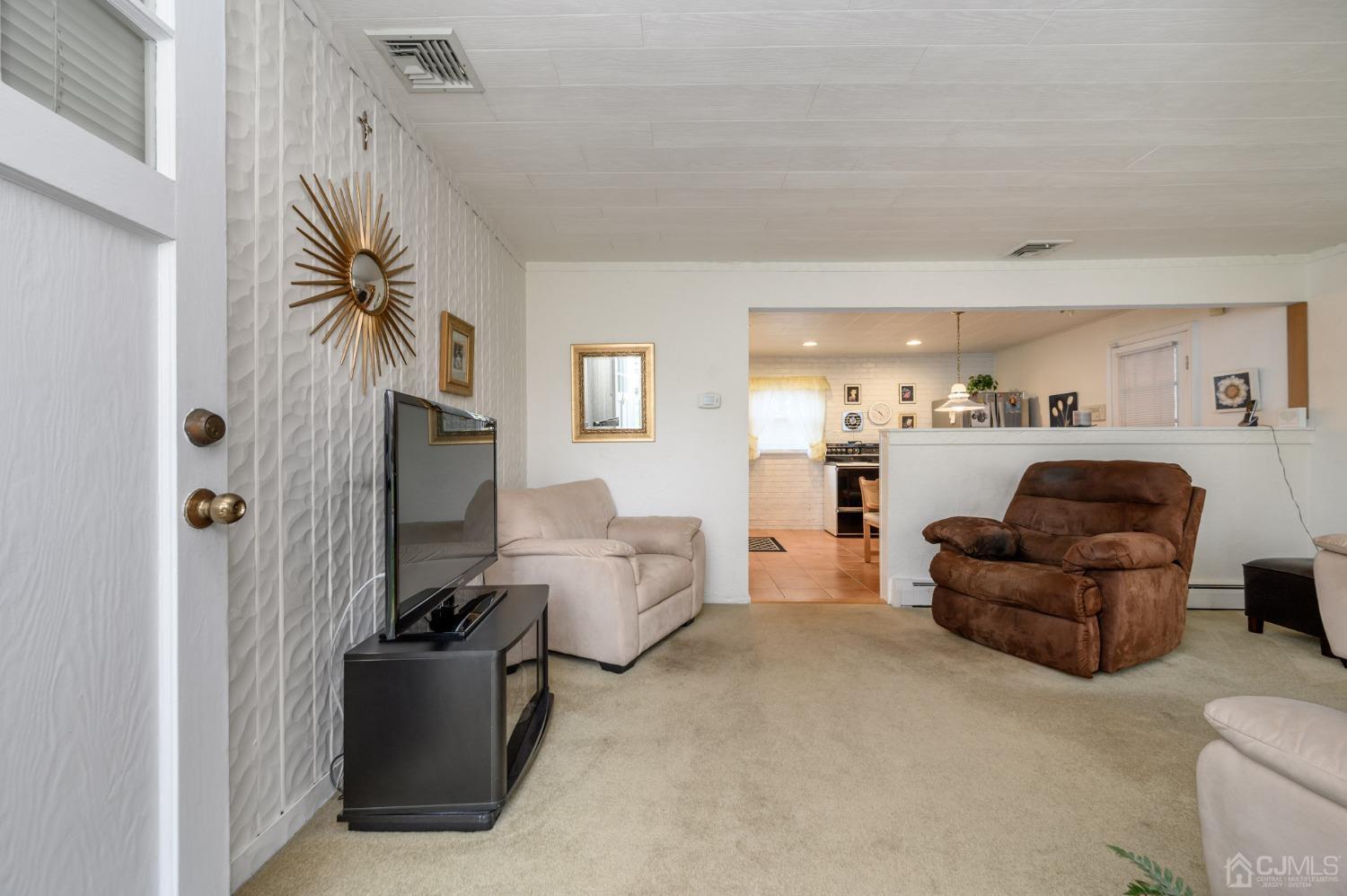 56 Normandy Road Colonia, NJ 07067 - Photo 3 of 25 a living room with furniture and a flat screen tv