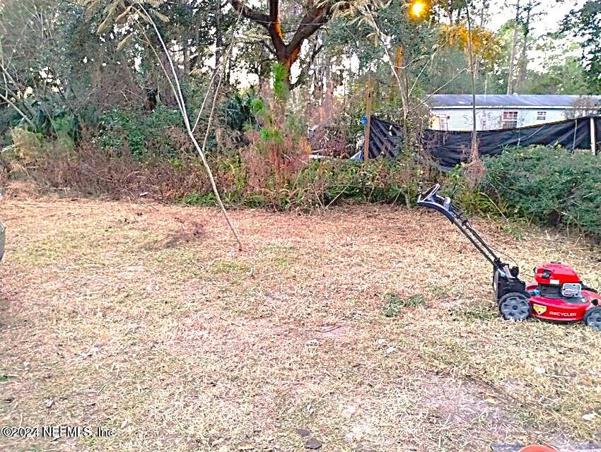 104 Riverside Lane Palatka, FL 32177 - Photo 2 of 22 a view of a backyard with a small cabin