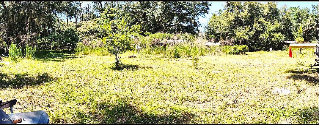 104 Riverside Lane Palatka, FL 32177 - Photo 9 of 22 a swimming pool with trees in the background