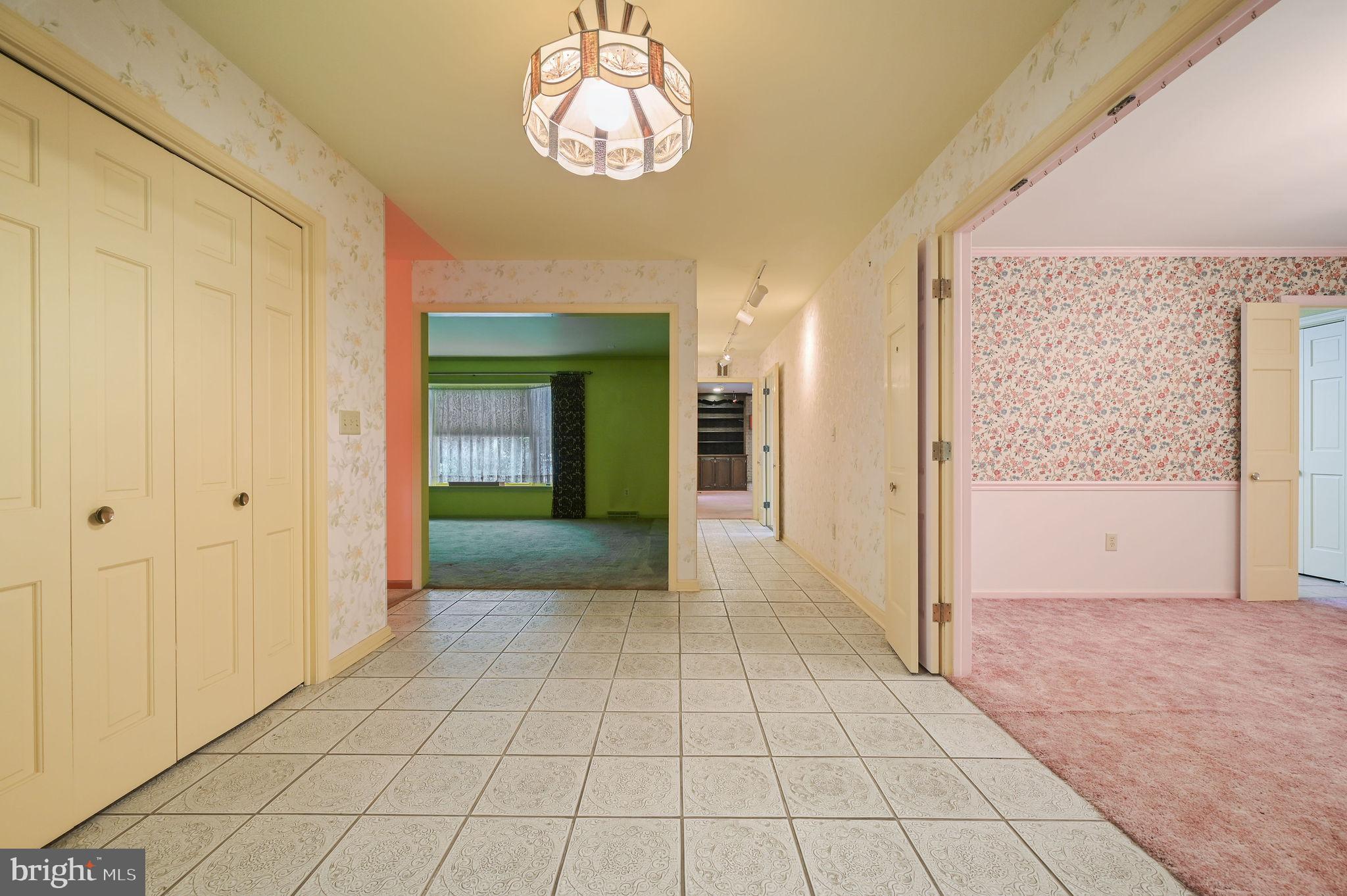 235 Carnoustie Road Dover, DE 19904 - Photo 15 of 30 a view of a hallway with a chandelier