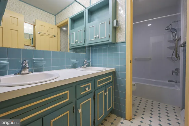 a view of a hallway with a ceiling fan