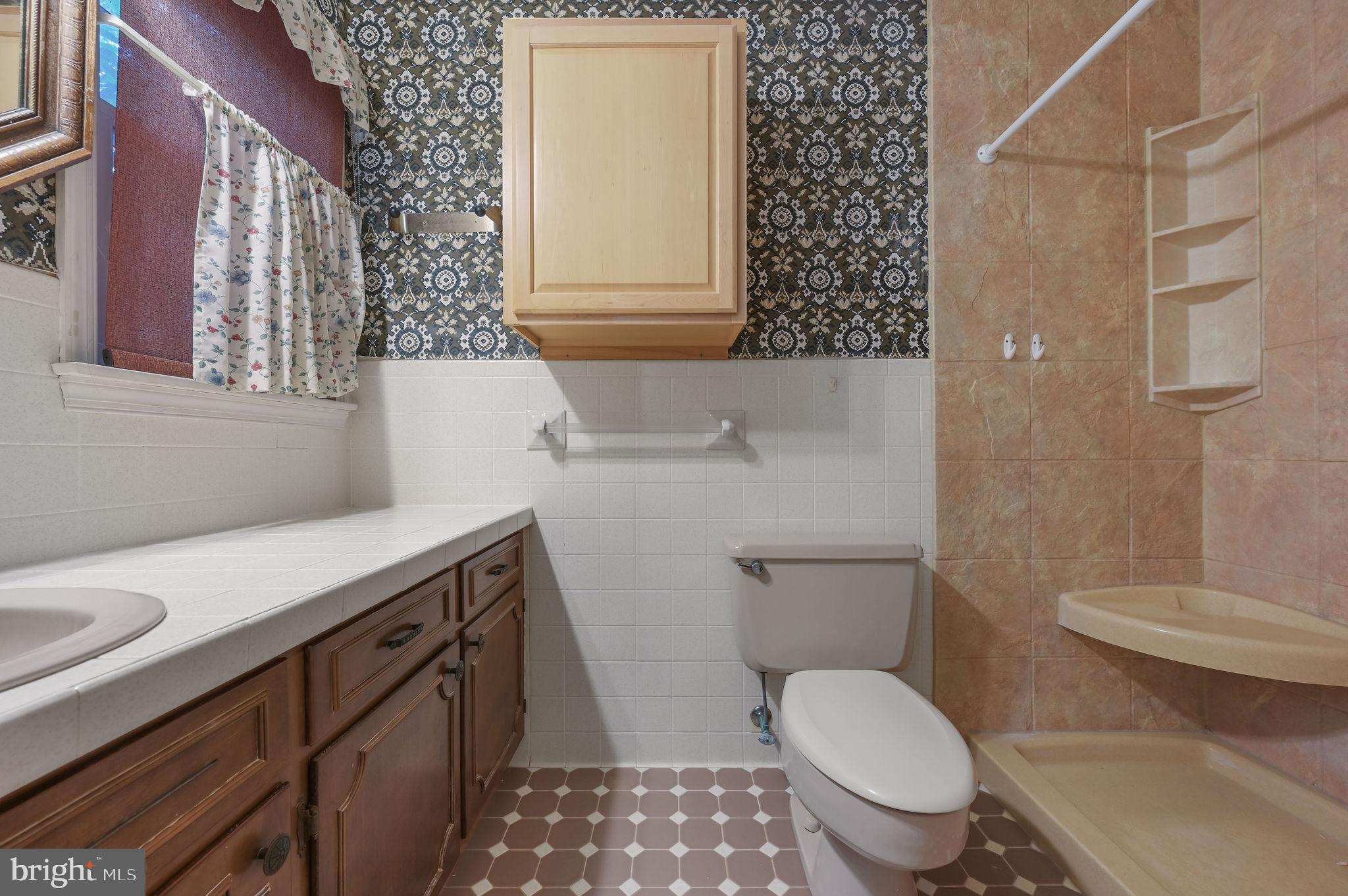 235 Carnoustie Road Dover, DE 19904 - Photo 21 of 30 a bathroom with a sink toilet vanity and shower