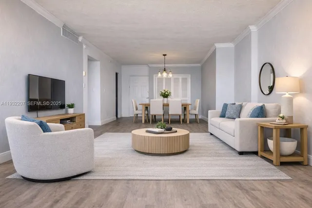 a living room with furniture and a chandelier