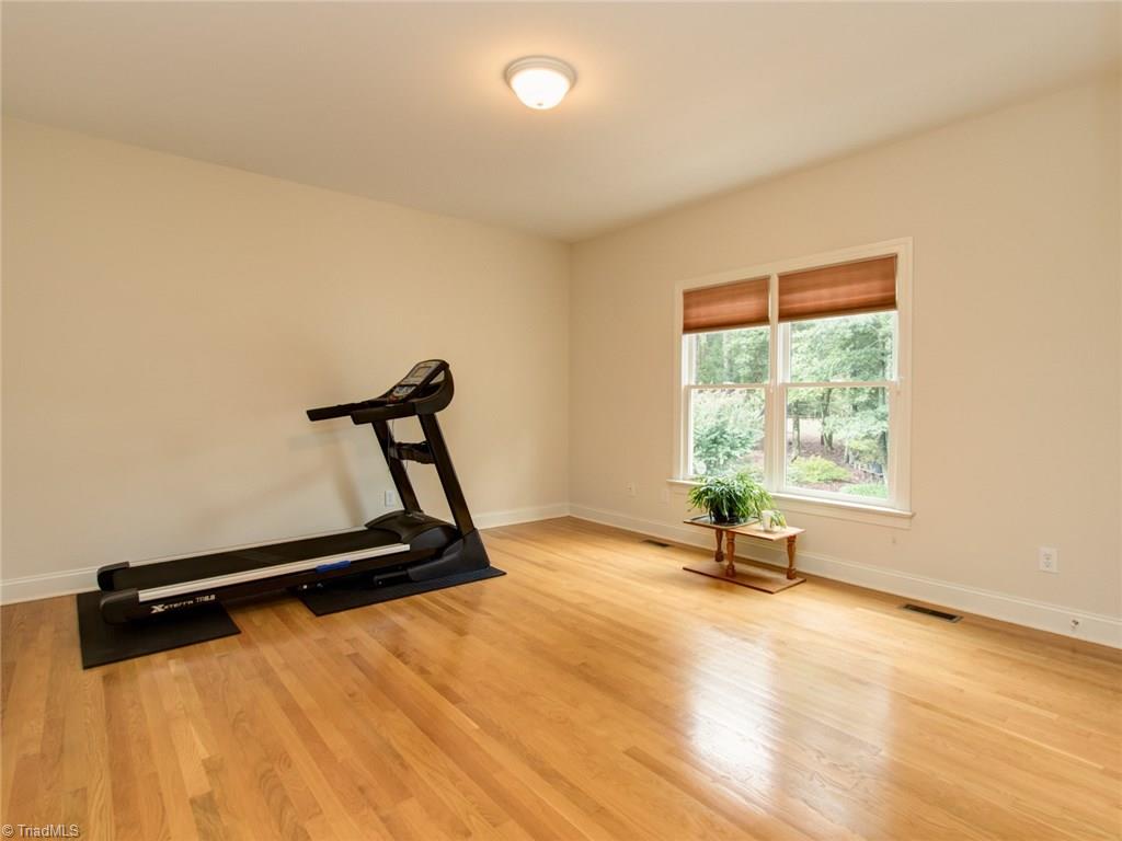 6001 Dunvagen Court Oak Ridge, NC 27310 - Photo 14 of 30 Spacious bedroom on main level with it's own bath. Beautiful hardwood flooring!