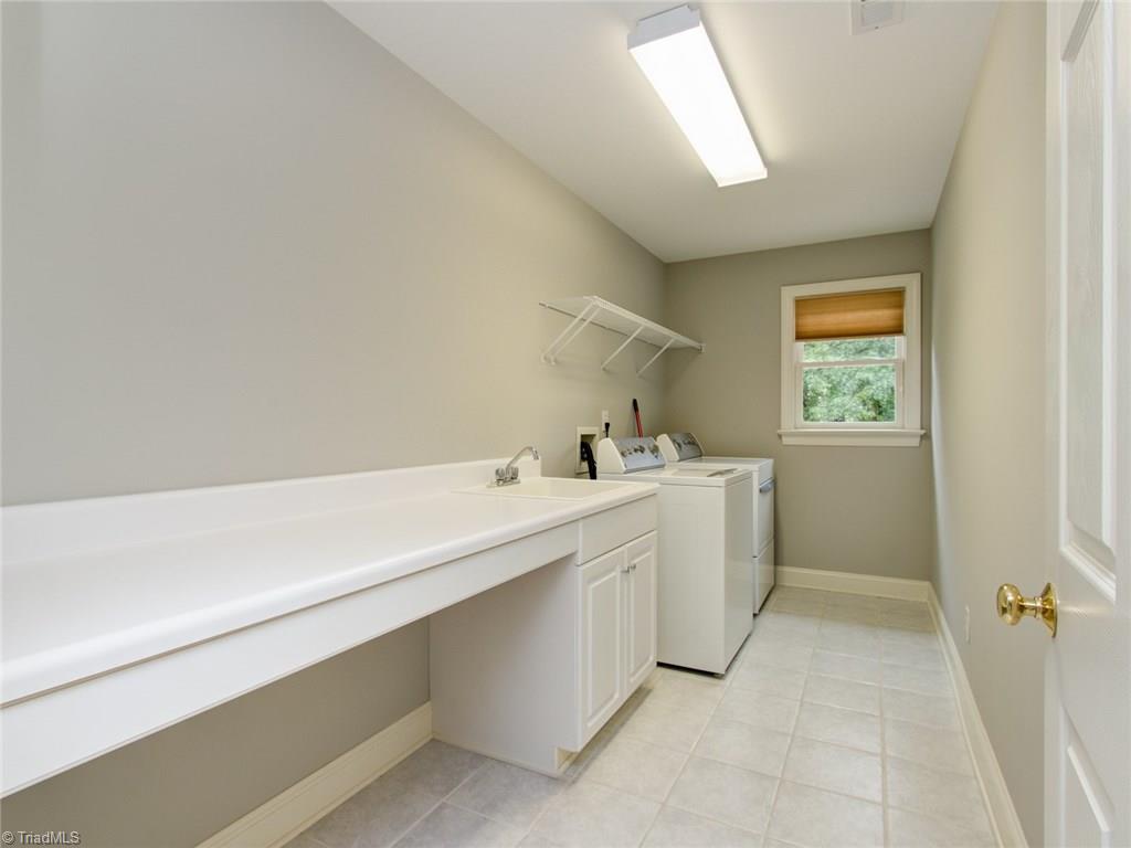 6001 Dunvagen Court Oak Ridge, NC 27310 - Photo 24 of 30 Great Laundry Room with sink and folding table!