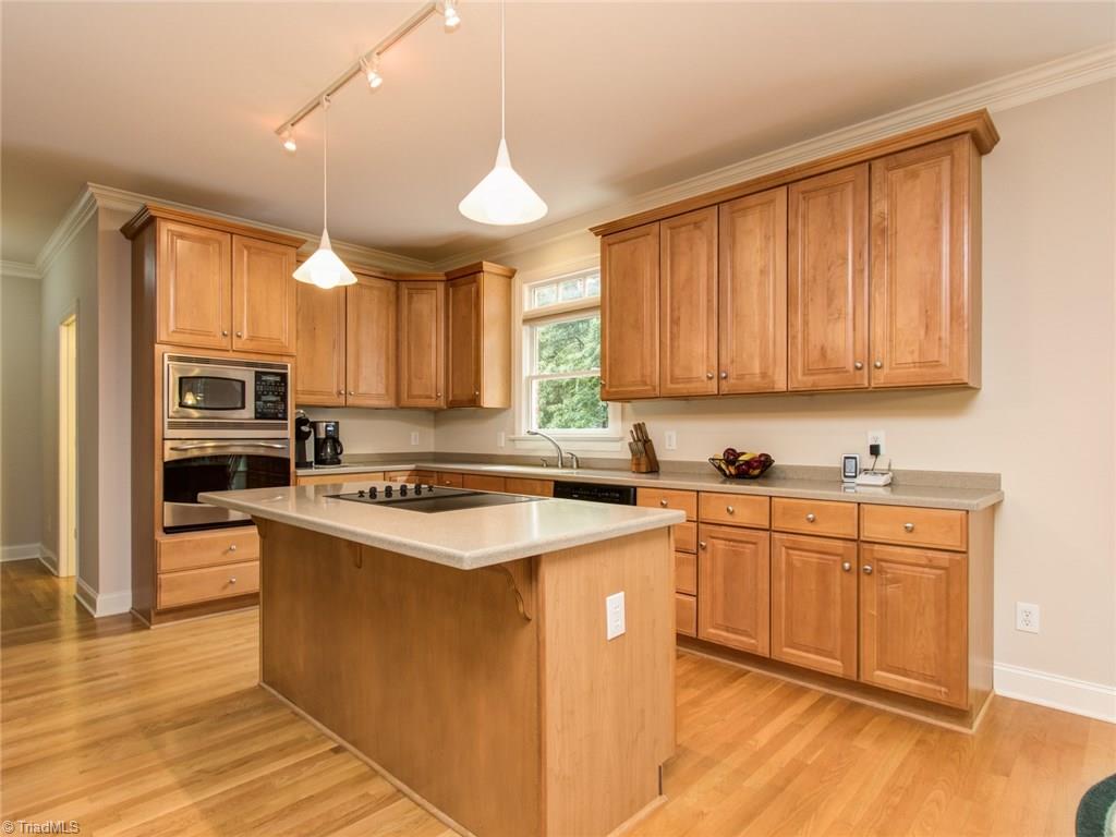 6001 Dunvagen Court Oak Ridge, NC 27310 - Photo 7 of 30 Maple cabinetry, pendant lighting and island...