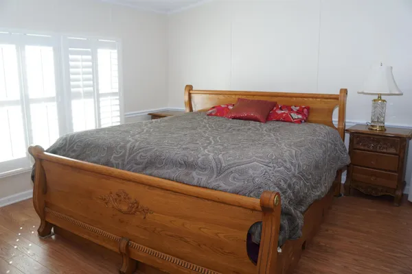 a bed sitting in a bedroom next to a window