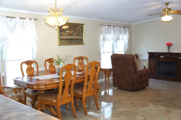 a view of a dining room with furniture and chandelier