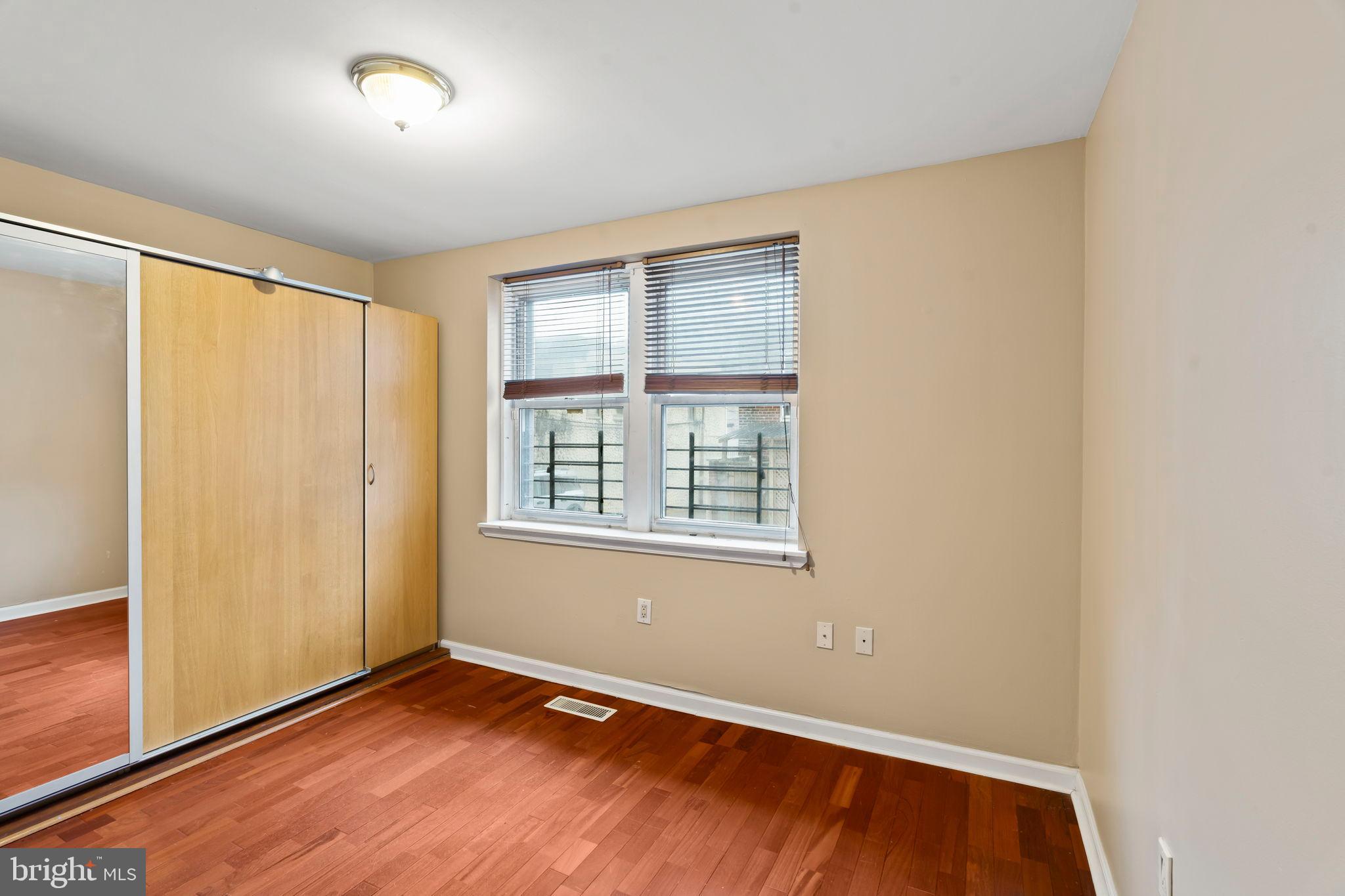 1828-00 Green Street, Unit 1R Philadelphia, PA 19130 - Photo 12 of 37 an empty room with wooden floor and windows