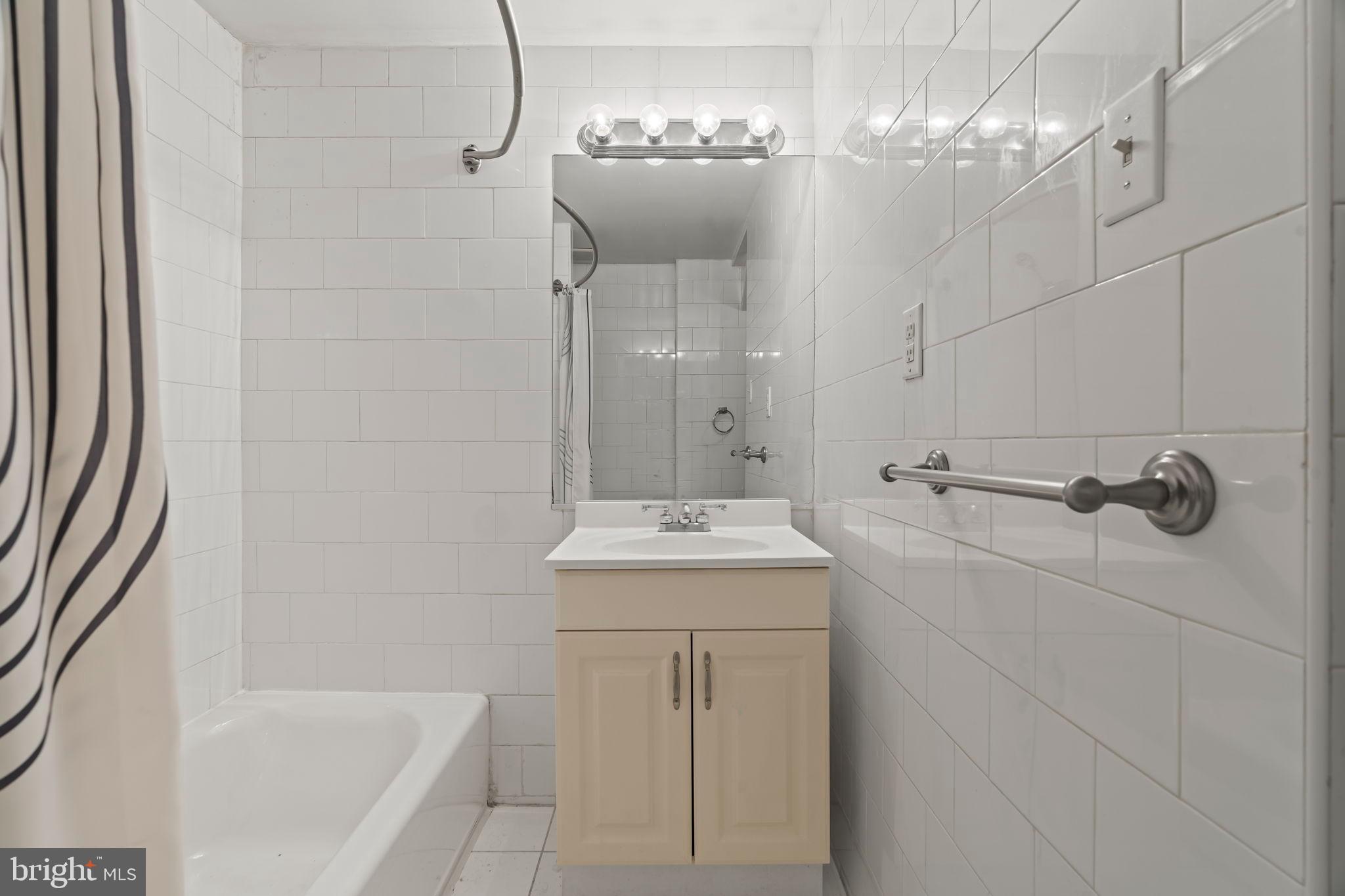 1828-00 Green Street, Unit 1R Philadelphia, PA 19130 - Photo 19 of 37 a bathroom with a sink a toilet and shower