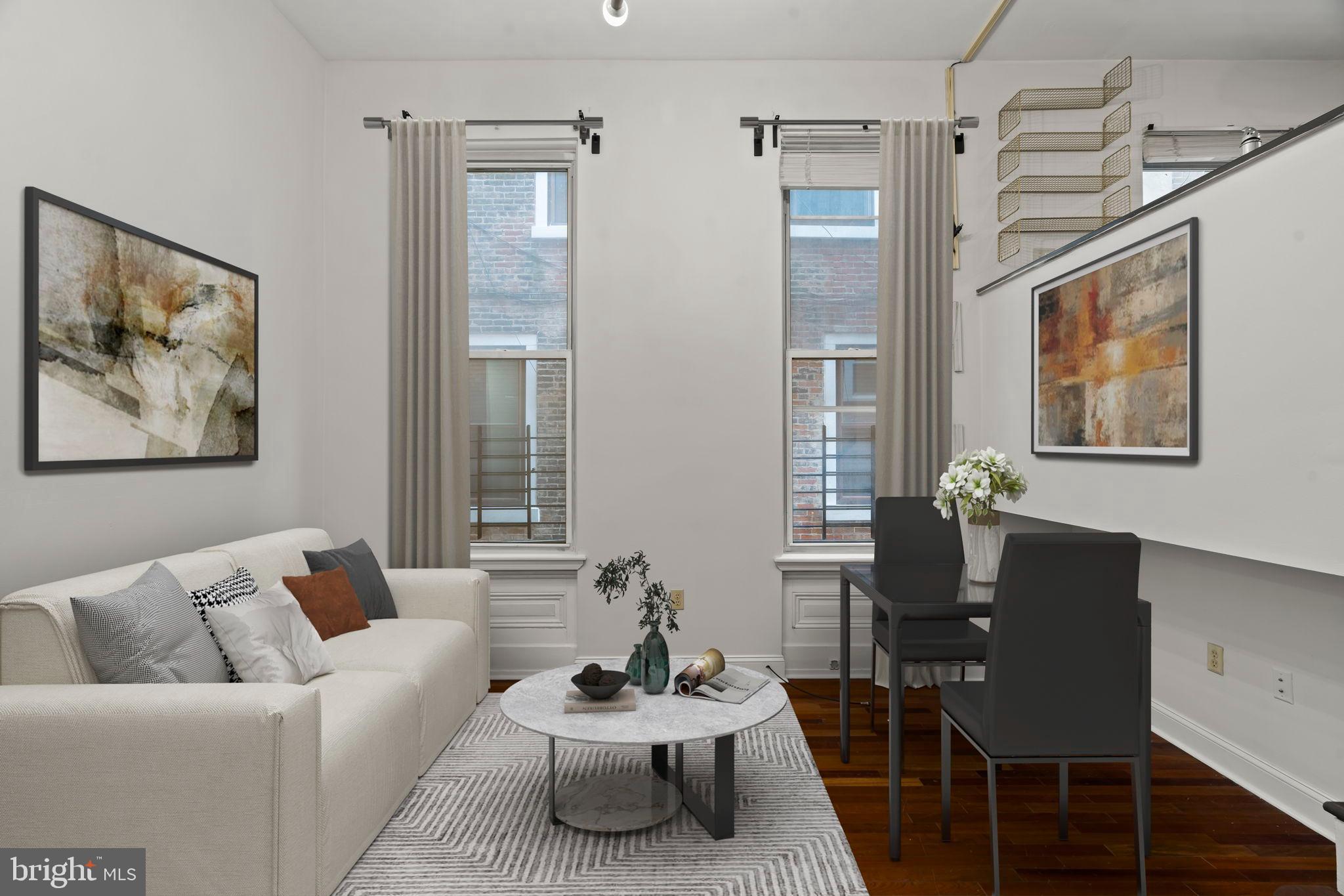 1828-00 Green Street, Unit 1R Philadelphia, PA 19130 - Photo 4 of 37 a living room with furniture and a potted plant