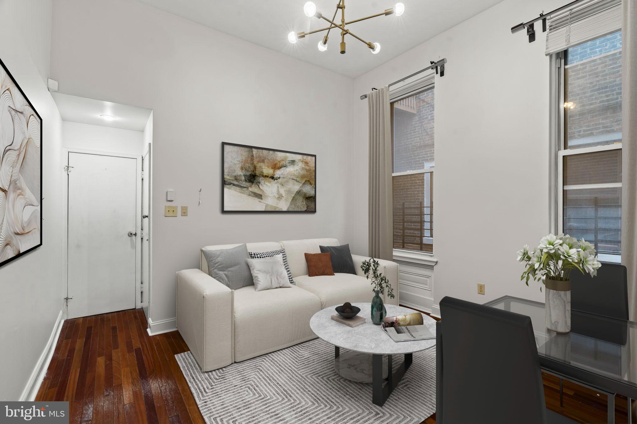 1828-00 Green Street, Unit 1R Philadelphia, PA 19130 - Photo 5 of 37 a living room with furniture and a potted plant