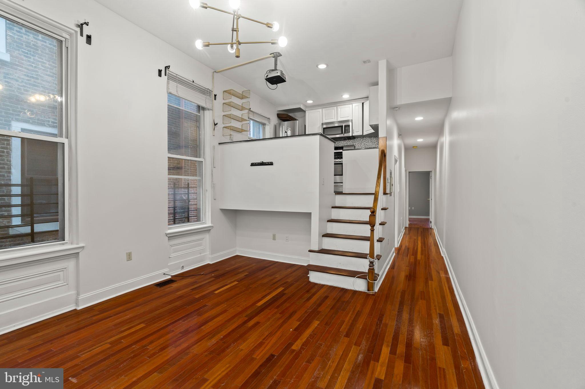 1828-00 Green Street, Unit 1R Philadelphia, PA 19130 - Photo 7 of 37 a view of kitchen with cabinets and wooden floor
