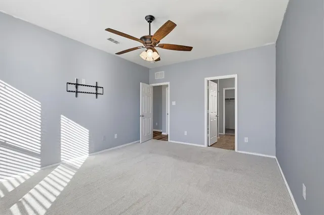 a view of a livingroom with a ceiling fan and window