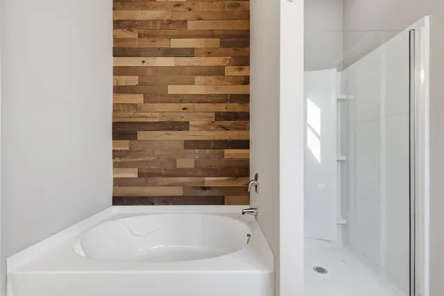 a bathroom with bathtub and shower