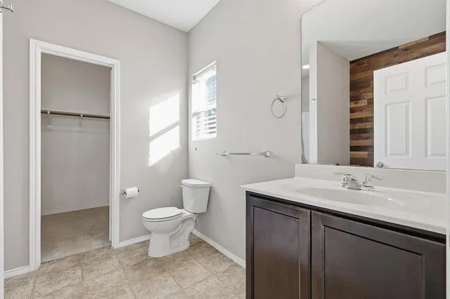 a bathroom with a sink toilet and a mirror