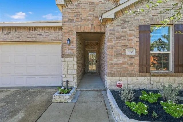 a view of entrance of the building with potted plants