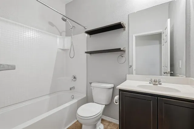 a bathroom with a sink toilet vanity and shower